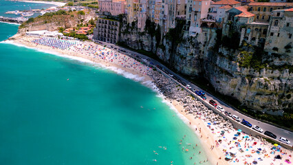 Fototapeta na wymiar Aerial view of Famous Italian town Tropea: Colorful Houses and Turquoise Waters Along Italy's Picturesque Coast 