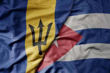 big waving realistic national colorful flag of barbados and national flag of cuba .