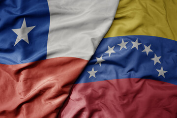 big waving realistic national colorful flag of chile and national flag of venezuela .