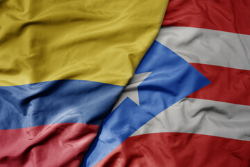 big waving realistic national colorful flag of colombia and national flag of puerto rico .