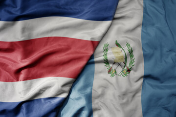 big waving realistic national colorful flag of chile and national flag of guatemala .