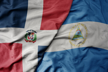 big waving realistic national colorful flag of cuba and national flag of nicaragua .