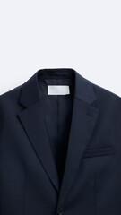 Closeup of dark blue suit, isolated on vertical copy-space background.