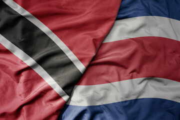 big waving realistic national colorful flag of trinidad and tobago and national flag of costa rica .