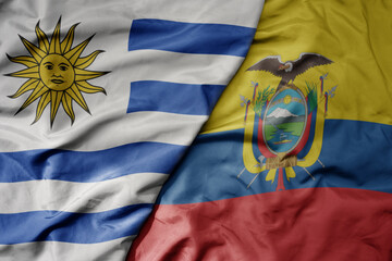 big waving realistic national colorful flag of uruguay and national flag of ecuador .