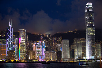 Naklejka premium Light show or laser show over Hong Kong Island City skyline at night.