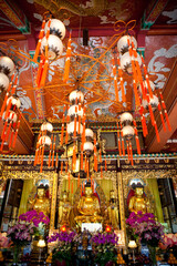 Gold Buddha statues inside Po Lin (Precious Lotus) Monastery in Ngong Ping Village on Lantau Island...