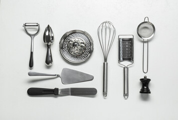 Set of different kitchen utensils on white table, flat lay