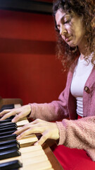 Talented Young Woman playing Melodies on a Vintage Piano. vertical, copy space.