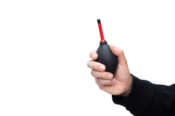 A man holding a dust blower for cleaning lenses and cameras isolated on a white background. Cleaning tools. Rubber pump dust cleaner.