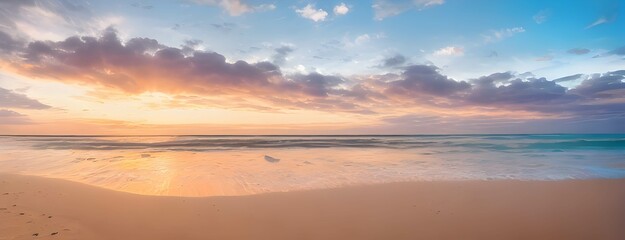 Fototapeta na wymiar 青空とオレンジ色の夕焼けがグラデーションするビーチの美しい風景