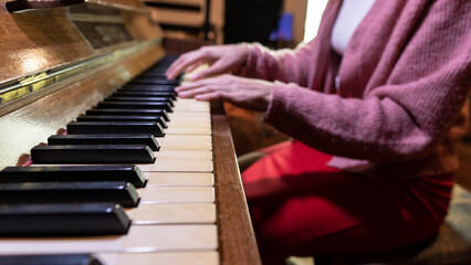 Young woman hands playing Vintage Piano. Close up, copy space.