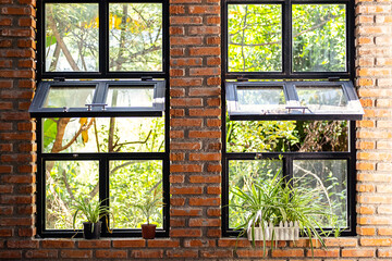 Modern workshop with big windows and indoor garden. Landscaped coworking space.