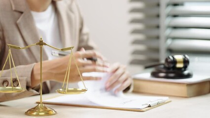 Young Female lawyer signing paper contract at office.