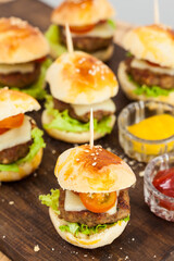 Ready to serve mini hamburgers. Step by step preparation of mini burgers. Homemade mini burgers for children or appetizers. Small hamburgers.