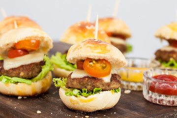 Ready to serve mini hamburgers. Step by step preparation of mini burgers. Homemade mini burgers for children or appetizers. Small hamburgers.