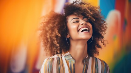 Laughing young woman on a colorful background