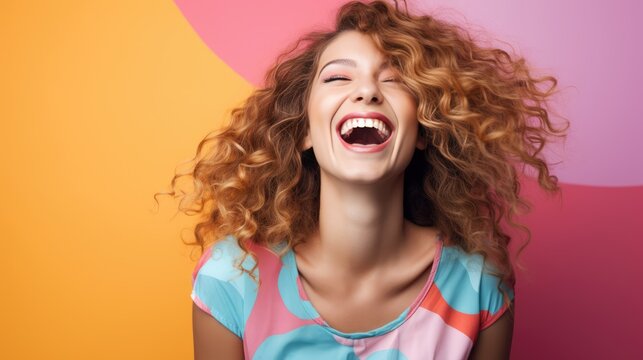 Laughing young woman on a colorful background
