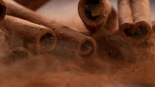 Cinnamon sticks falling in slow motion.