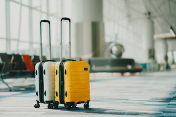 Two suitcases in an empty airport hall, traveler cases in the departure airport terminal waiting for the area, vacation concept, blank space for text message or design