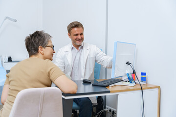 Doctor consulting a female patient during appointment in modern clinic. High quality photo