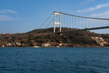 The neighbourhood on the Asian side of the Bosphorus strait Kanlıca in the Beykoz district of Istanbul Province on the backgrounds of the Sultan Mehmed Fatih Bridge on a sunny day, Istanbul, Turkey