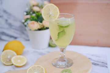 Lemonade with lime, mint and ice on a white background