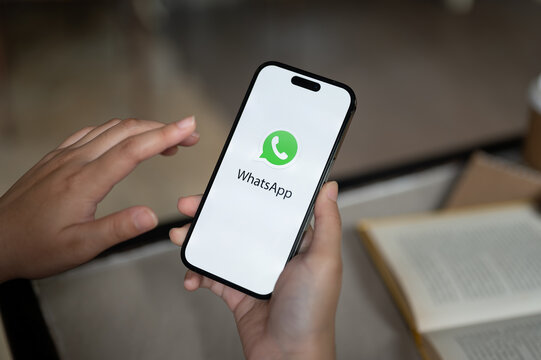 A female using WhatsApp on her iPhone14. close-up image