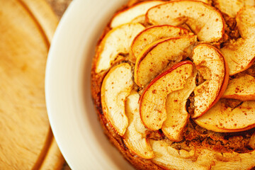 Home cookery concept. Top view of apple pie on white porcelain plate. Close up. Indoor shot. Text space