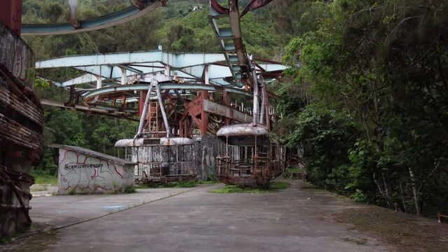 Backward dolly drone flight inside the ruins of the old cable car station El Liron, located in San Antonio de Galipan, Venezuela