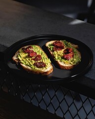 bread with chipotle guacamole, on a black ceramic plate, with direct natural light, typical mexican food, latin america