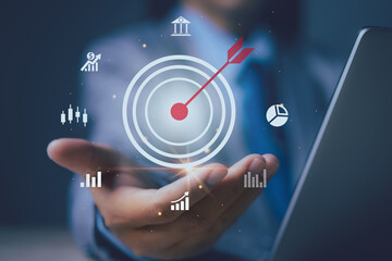 Businessman hand holding arrow dart icon and management target, success and planning. Financial and banking, Digital link tech, investment goal and target for business investment concept