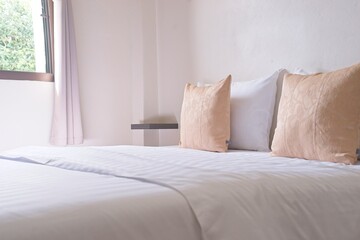 white cozy bedroom, decor idea and design, home interior decoration. light brown pillow side view