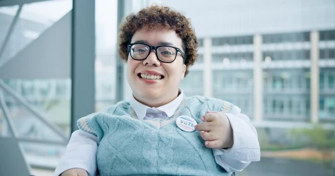 Smile, vote and a woman with a disability pointing to a badge in support of freedom or democracy. Portrait, face and wheelchair of her choice, decision or selection of political party in the election