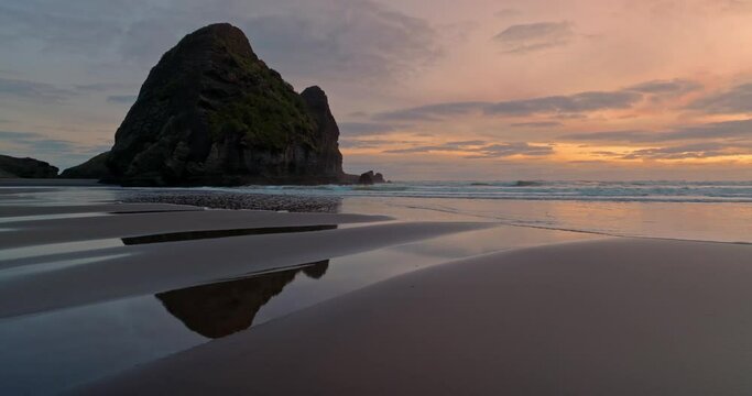 Aerial: Beautiful sandy beach at sunset with waves, New Zealand