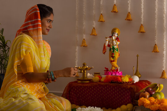 Woman worshipping Lord Krishna on the occasion of Janmashtami