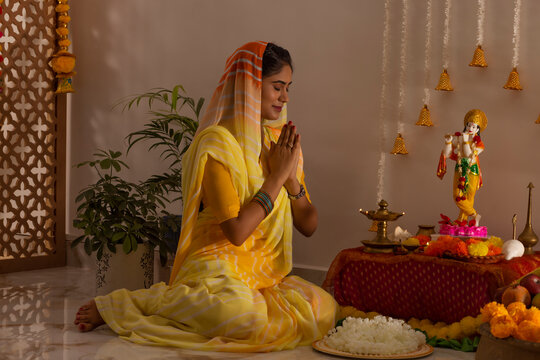 Woman praying to Lord Krishna on the occasion of Janmashtami