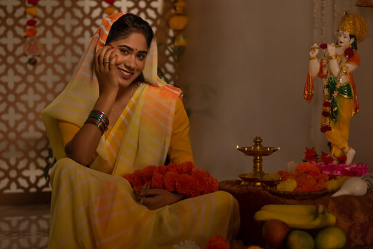 Woman worshipping Lord Krishna on the occasion of Janmashtami