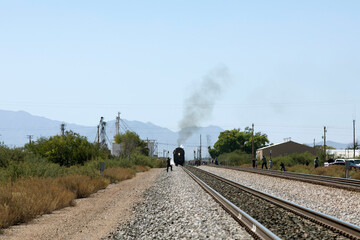 Smoke bellows from distant steam locomotive