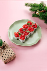 Obraz na płótnie Canvas japanese sushi rolls with a tuna cap on a plate. new year's deco