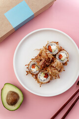 japanese sushi rolls with tuna chips on a white plate