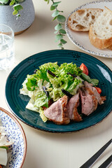 steak salad in a blue plate. restaurant menu