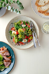 nicoise salad with tuna and quail eggs . restaurant menu