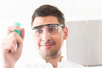 scientist male with labor glasses looking to a sample