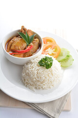 signature Malay nonya spicy chilli curry leaf chicken and potato with steamed jasmine white rice and vegetable salad in plate on white background asian halal food cuisine menu for cafe design