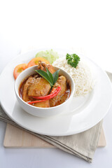 signature Malay nonya spicy chilli curry leaf chicken and potato with steamed jasmine white rice and vegetable salad in plate on white background asian halal food cuisine menu for cafe design