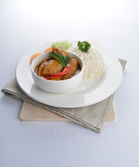 signature Malay nonya spicy chilli curry leaf chicken and potato with steamed jasmine white rice and vegetable salad in plate on white background asian halal food cuisine menu for cafe design