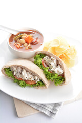 chicken tuna salad kebab open pocket bread with tomato abc soup and crispy potato chips combo healthy set in plate on white background asian halal food cuisine vegan menu for cafe design