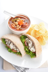 chicken tuna salad kebab open pocket bread with tomato abc soup and crispy potato chips combo healthy set in plate on white background asian halal food cuisine vegan menu for cafe design
