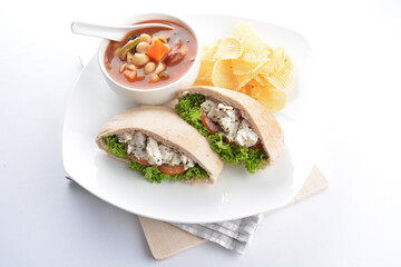 chicken tuna salad kebab open pocket bread with tomato abc soup and crispy potato chips combo healthy set in plate on white background asian halal food cuisine vegan menu for cafe design